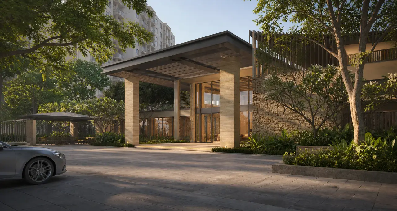 Urbanrise Begur Koppa modern clubhouse arrival court with a deep canopy, warm stone and tropical planting
